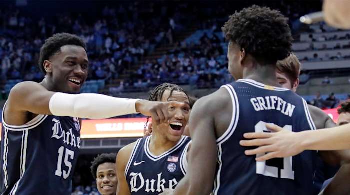 Duke center Mark Williams (15) and forward Wendell Moore Jr. (0) congratule forward A.J. Griffin (21) as he comes out of the game late in the second half of an NCAA college basketball game, Saturday, Feb. 5, 2022, in Chapel Hill, N.C. Griffin was Duke's leading scorer.